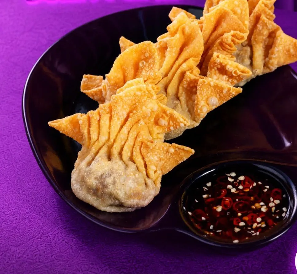 Crispy cheese and chicken wontons with a chili dip.