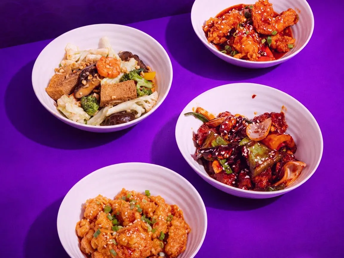 Four bowls of wok-fried mains seen from above.